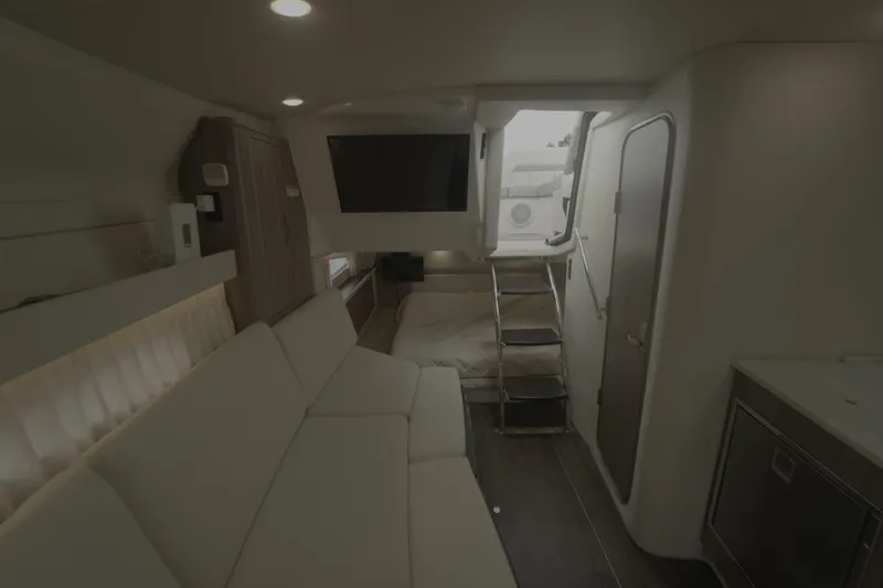 Slide: The Image of Interior of 2021 Regal 33 XO yacht with modern seating and entertainment area. - 22