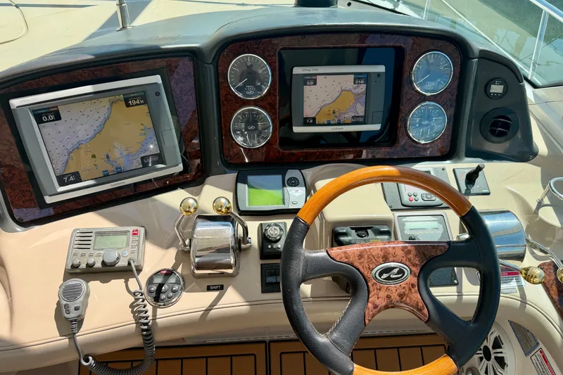 Slide: The Image of Helm of 2006 Sea Ray 52 Sundancer with navigation screens and controls. - 47