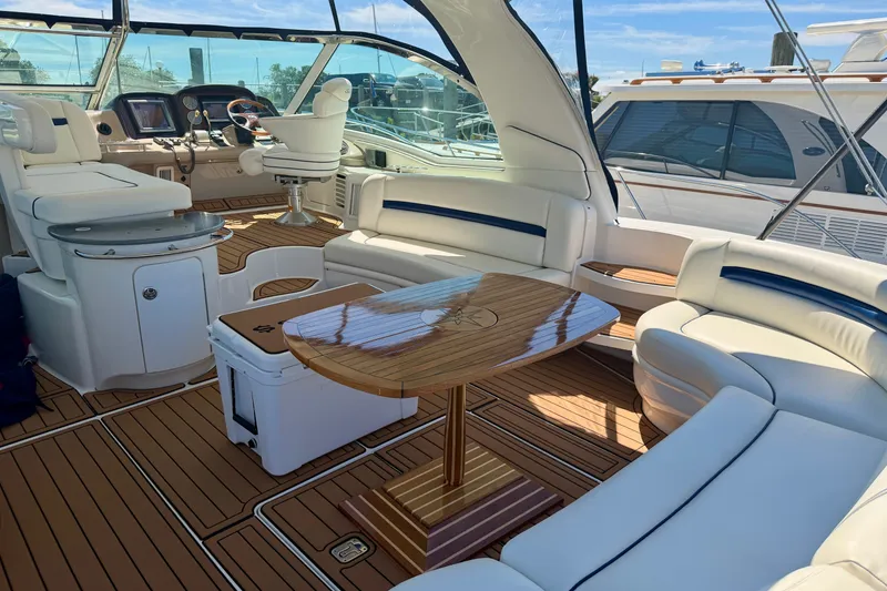 Slide: The Image of Luxurious 2006 Sea Ray 52 Sundancer yacht interior with elegant seating and polished wood table. - 50
