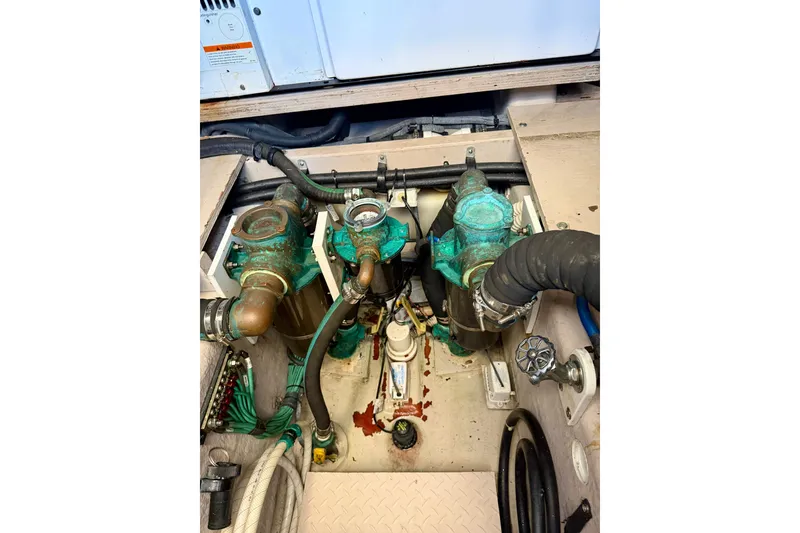 Slide: The Image of Engine compartment of a 2006 Sea Ray 52 Sundancer with visible hoses and components. - 60