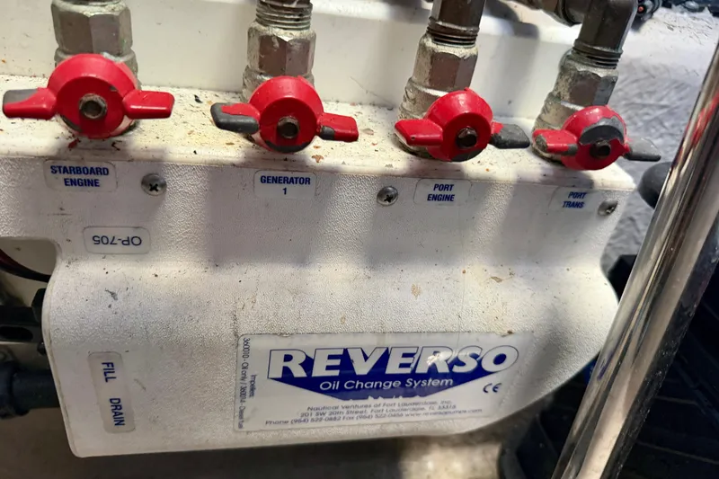 Slide: The Image of Reverso oil change system with red valves on a 2006 Sea Ray 52 Sundancer. - 59