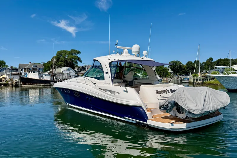 Slide: The Image of 2006 Sea Ray 52 Sundancer yacht docked in a serene marina setting. - 19