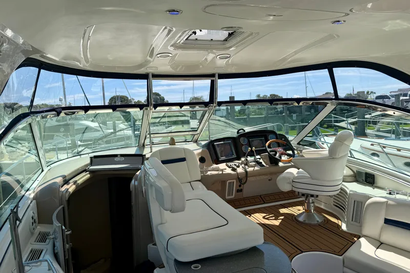 Slide: The Image of Luxurious 2006 Sea Ray 52 Sundancer yacht interior with helm and seating area. - 51