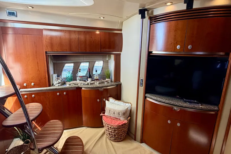Slide: The Image of Luxurious interior of 2006 Sea Ray 52 Sundancer yacht with wooden cabinetry and modern amenities. - 42