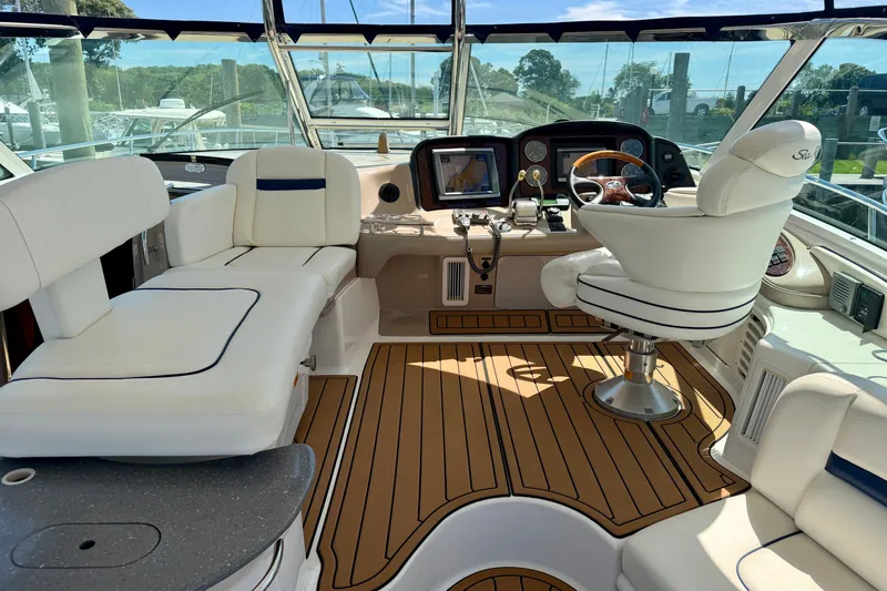 Slide: The Image of 2006 Sea Ray 52 Sundancer cockpit with luxurious seating and modern navigation equipment. - 49