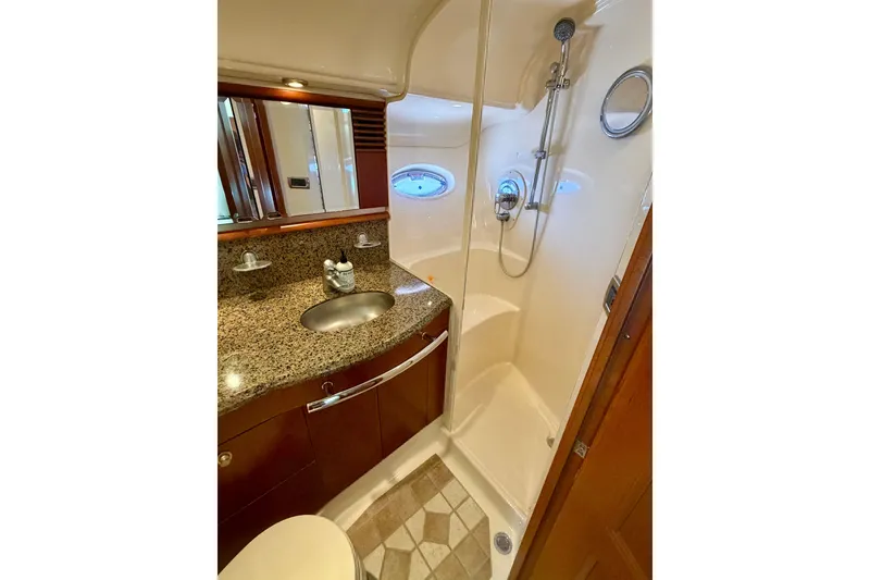 Slide: The Image of Luxurious bathroom in 2006 Sea Ray 52 Sundancer yacht with granite countertop and shower. - 35