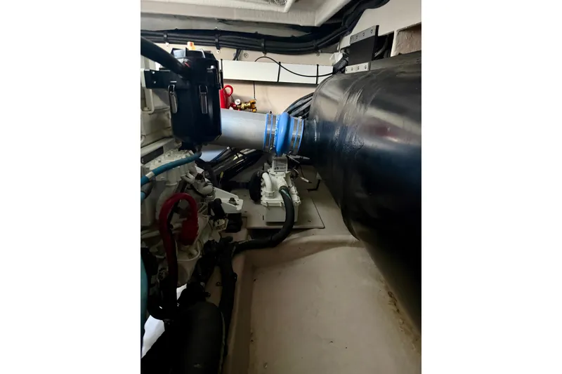 Slide: The Image of Engine room of a 2006 Sea Ray 52 Sundancer yacht, showcasing mechanical components. - 58