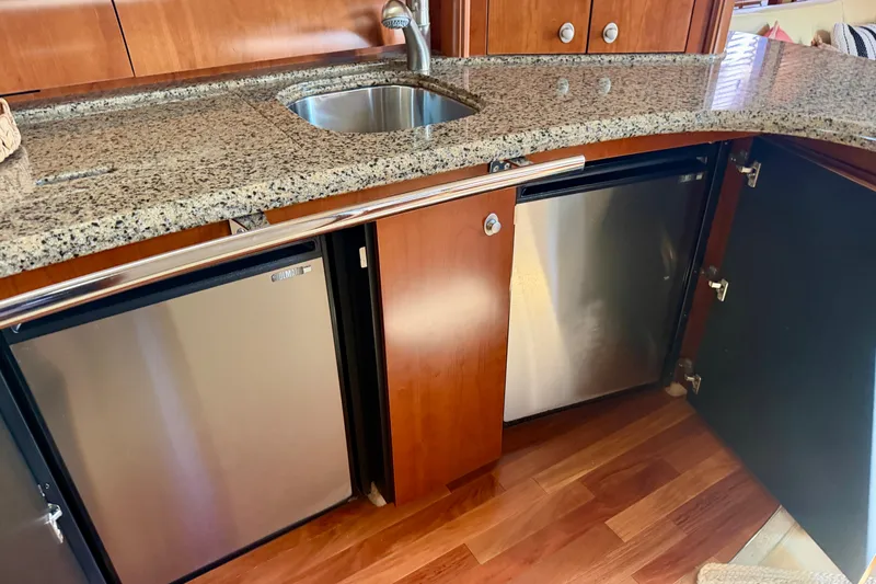 Slide: The Image of Luxurious 2006 Sea Ray 52 Sundancer yacht kitchen with granite countertop and stainless steel appliances. - 45