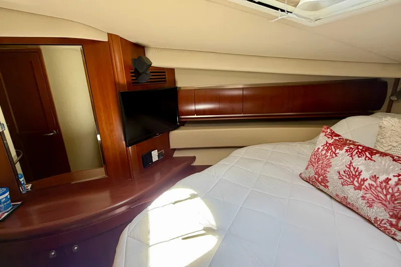 Slide: The Image of Luxurious cabin interior of 2006 Sea Ray 52 Sundancer with elegant wood finish and cozy bedding. - 33
