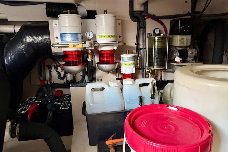 Slide: The Image of Engine room of a 2006 Sea Ray 52 Sundancer with fuel filters and containers. - 57
