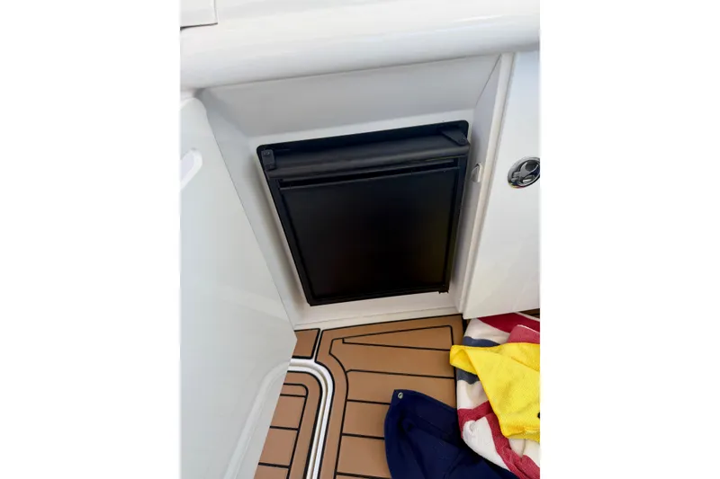 Slide: The Image of Mini fridge on 2006 Sea Ray 52 Sundancer yacht with teak flooring and colorful towels. - 54