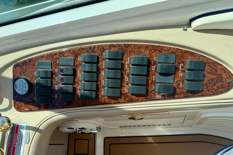 Slide: The Image of Control panel of a 2006 Sea Ray 52 Sundancer yacht with switches and gauges. - 48