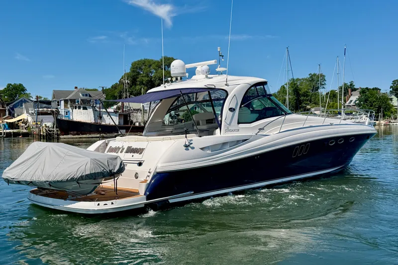 Slide: The Image of 2006 Sea Ray 52 Sundancer yacht cruising in a marina with clear blue skies. - 23
