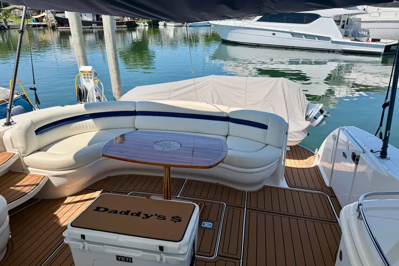 Slide: The Image of Luxurious 2006 Sea Ray 52 Sundancer yacht with elegant seating and wooden deck. - 52