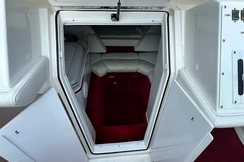 Slide: The Image of Interior cabin of a 2001 Fountain 29 Fever boat with red carpet and white seating. - 13