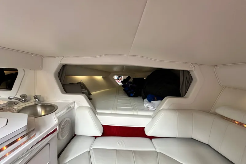 Slide: The Image of Interior of a 2001 Fountain 29 Fever boat, featuring white seating and compact amenities. - 16