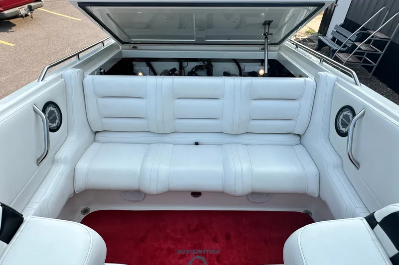 Slide: The Image of 2001 Fountain 29 Fever boat interior with white seating and open engine compartment. - 17