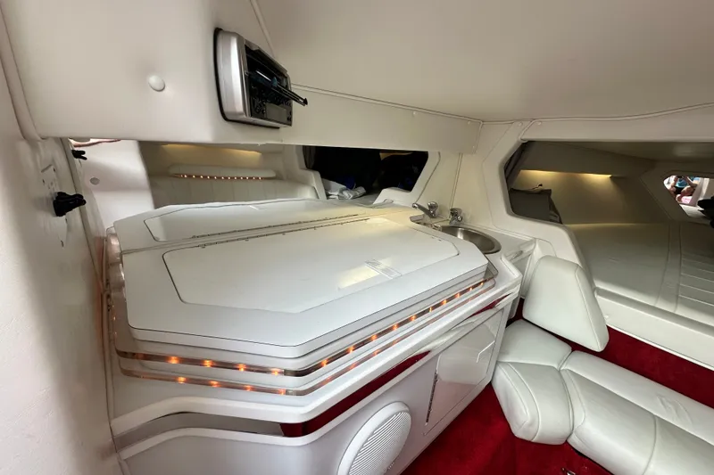 Slide: The Image of Interior of a 2001 Fountain 29 Fever boat with white seating and red carpet. - 14