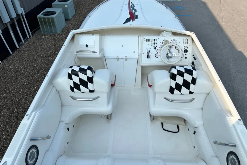 Slide: The Image of 2001 Fountain 29 Fever boat interior with checkered seats and control panel. - 22