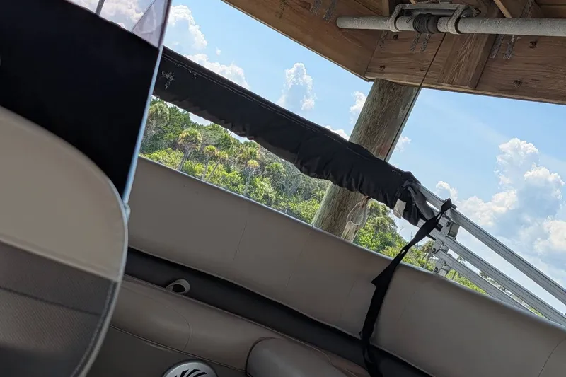 Slide: The Image of Interior view of a 2021 Sun Tracker Bass Buggy 16 XL boat under a wooden canopy. - 19