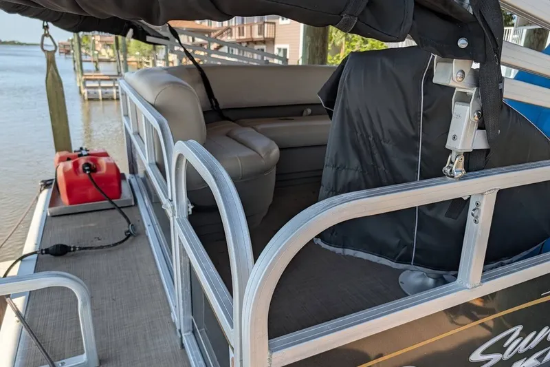 Slide: The Image of 2021 Sun Tracker Bass Buggy 16 XL pontoon boat interior with seating and railing. - 17