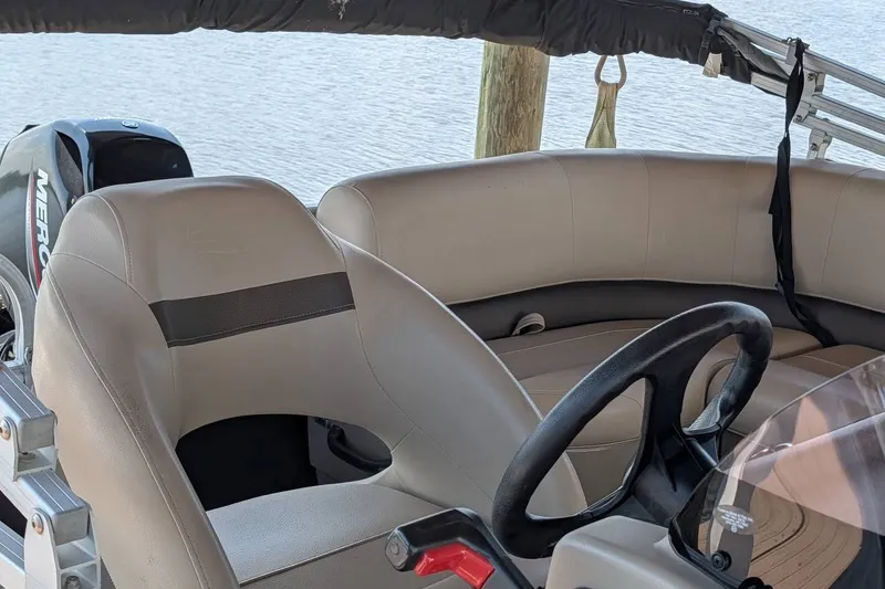 Slide: The Image of 2021 Sun Tracker Bass Buggy 16 XL interior with steering wheel and seating. - 20