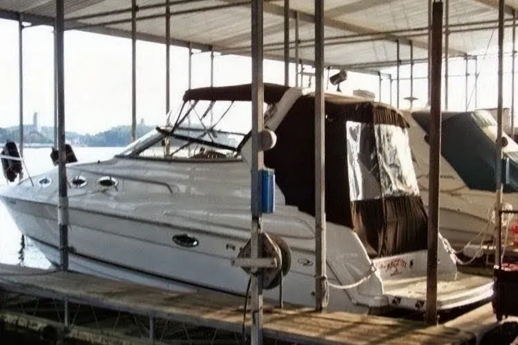 Slide: The Image of 2002 Regal Commodore 2860 boat docked in a covered marina. - 1