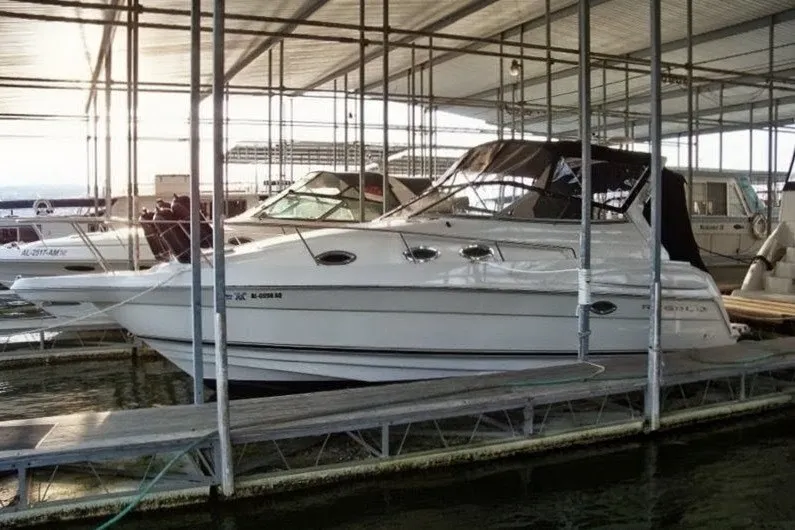 The Image of 2002 Regal Commodore 2860 boat docked in a covered marina. - 0