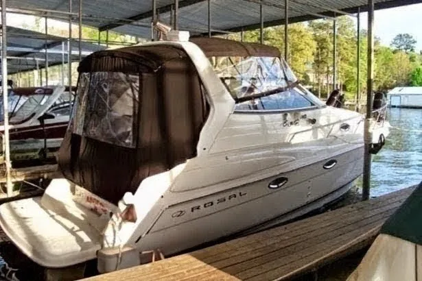 Slide: The Image of 2002 Regal Commodore 2860 boat docked under a covered marina. - 2