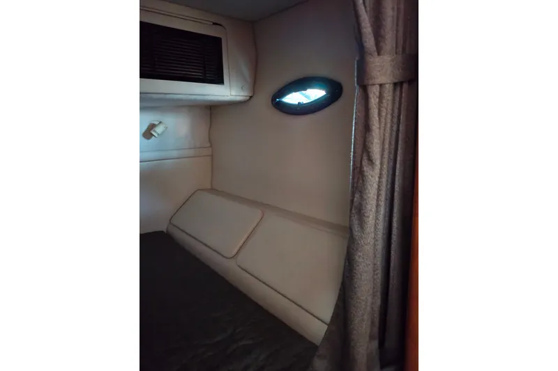 Slide: The Image of Interior cabin of 2002 Regal Commodore 2860 boat with window and curtain. - 42