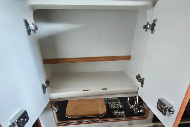 Slide: The Image of Open cabinet in Galley, showcasing storage space. - 39