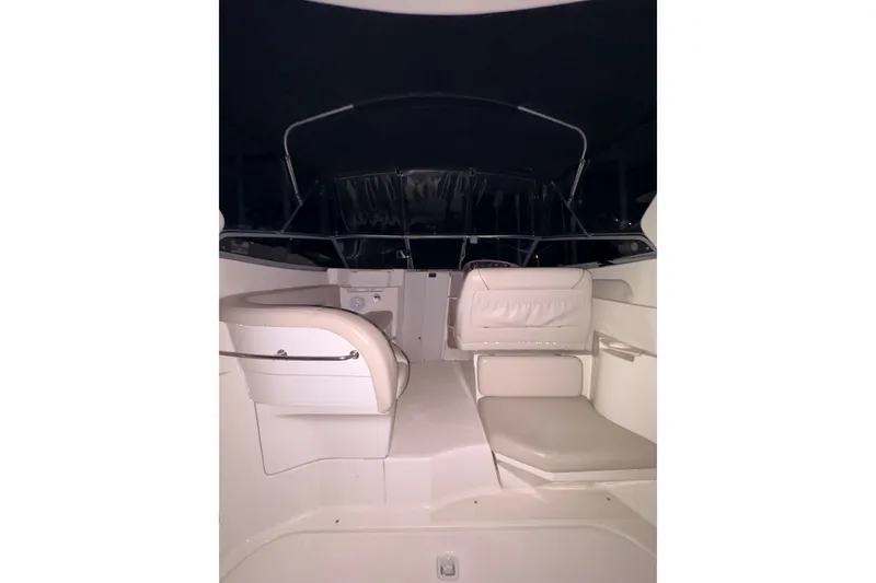 Slide: The Image of Interior of 2002 Regal Commodore 2860 boat with cushioned seating and canopy. - 9