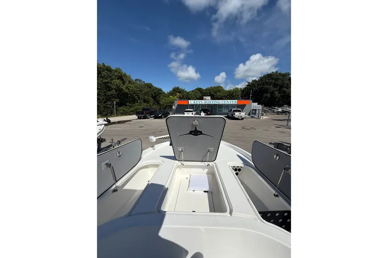 Slide: The Image of 2025 Turner Boatworks 2500 VS at a boating center, open storage compartments visible. - 12