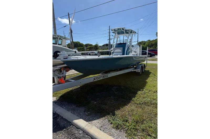 Slide: The Image of 2025 Turner Boatworks 2500 VS on trailer, parked outdoors under clear sky. - 2