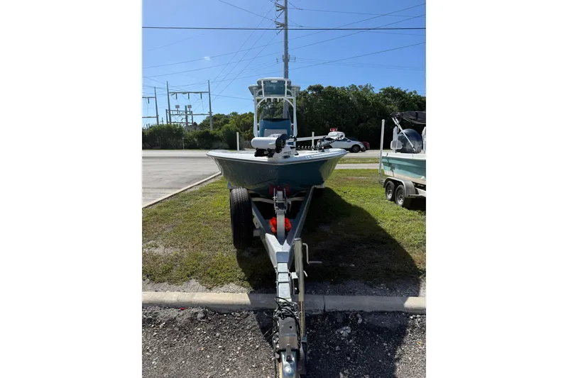 Slide: The Image of 2025 Turner Boatworks 2500 VS on trailer, parked outdoors under clear sky. - 1