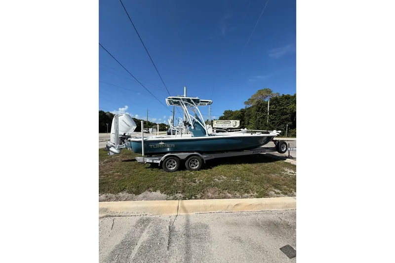 The Image of 2025 Turner Boatworks 2500 VS on trailer, parked outdoors under clear blue sky. - 0
