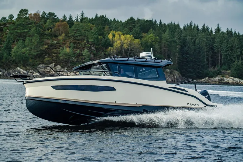 Slide: The Image of Manufacturer Provided Image: 2026 Navan C30 boat cruising on a scenic lake with forested background. - 1