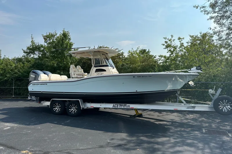 Slide: The Image of 2023 Grady-White 281 Coastal Explorer boat on trailer, parked outdoors. - 0