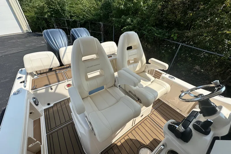Slide: The Image of 2023 Grady-White 281 Coastal Explorer boat interior with luxurious seating and dual engines. - 37