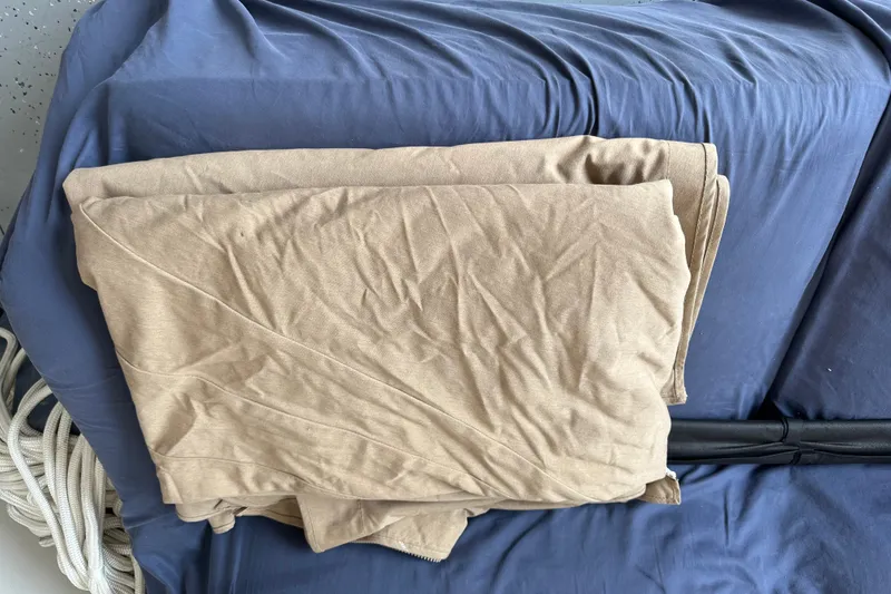 Slide: The Image of Folded beige fabric on a blue surface, possibly boat seating, Grady-White 281 Coastal Explorer. - 25