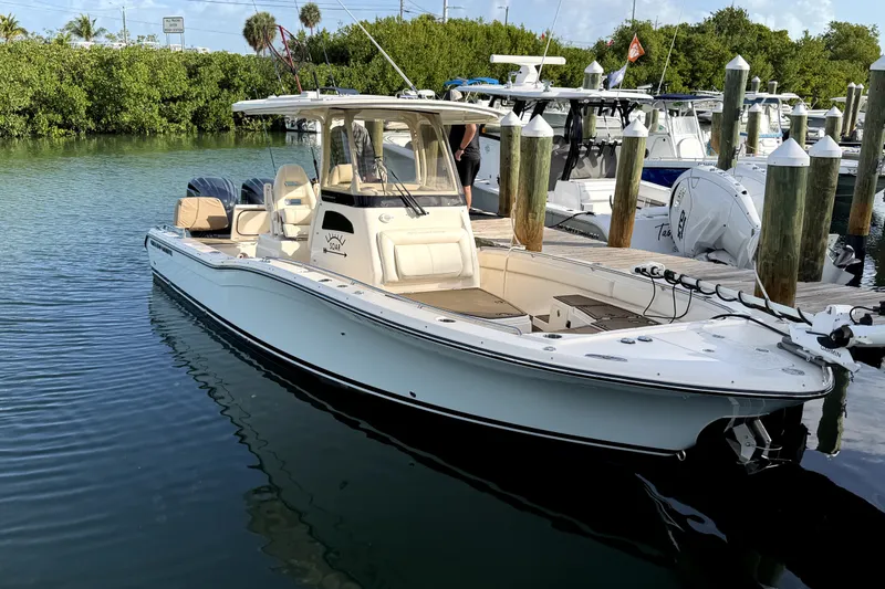 Slide: The Image of 2023 Grady-White 281 Coastal Explorer boat docked in a marina. - 7