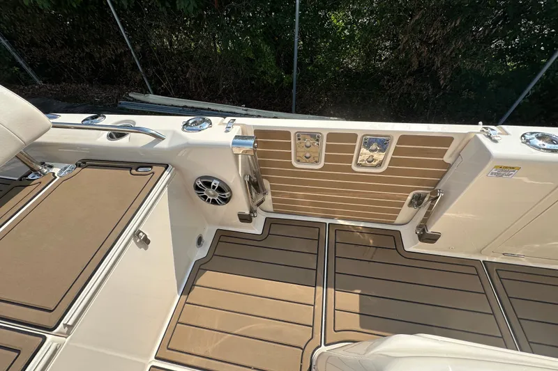 Slide: The Image of 2023 Grady-White 281 Coastal Explorer boat deck with seating and storage compartments. - 31