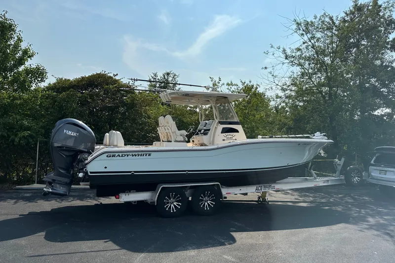 Slide: The Image of 2023 Grady-White 281 Coastal Explorer boat on trailer, parked outdoors. - 1