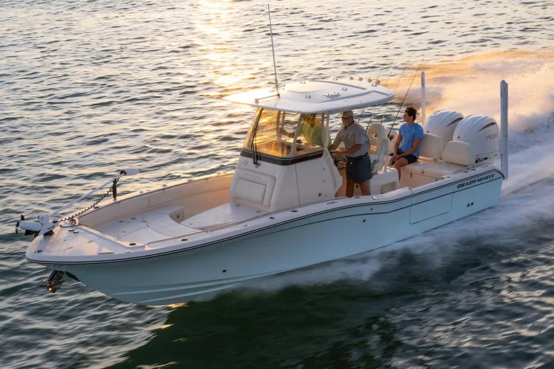 Slide: The Image of Manufacturer Provided Image: 2023 Grady-White 281 Coastal Explorer boat cruising on water at sunset. - 53