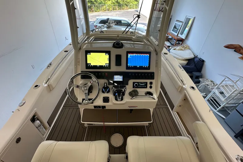 Slide: The Image of 2023 Grady-White 281 Coastal Explorer boat helm with modern navigation displays. - 13