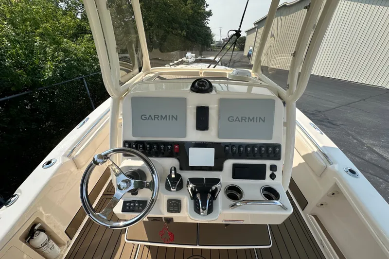 Slide: The Image of 2023 Grady-White 281 Coastal Explorer boat dashboard with Garmin navigation displays. - 12