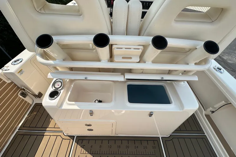 Slide: The Image of 2023 Grady-White 281 Coastal Explorer boat interior with rod holders and storage compartments. - 32