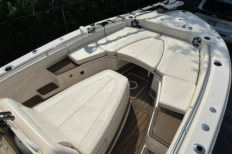 Slide: The Image of 2023 Grady-White 281 Coastal Explorer boat interior with cushioned seating and teak flooring. - 35