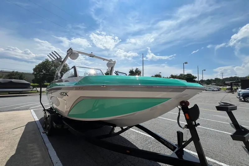Slide: The Image of 2020 Tigé 23ZX boat on trailer under a clear blue sky. - 3