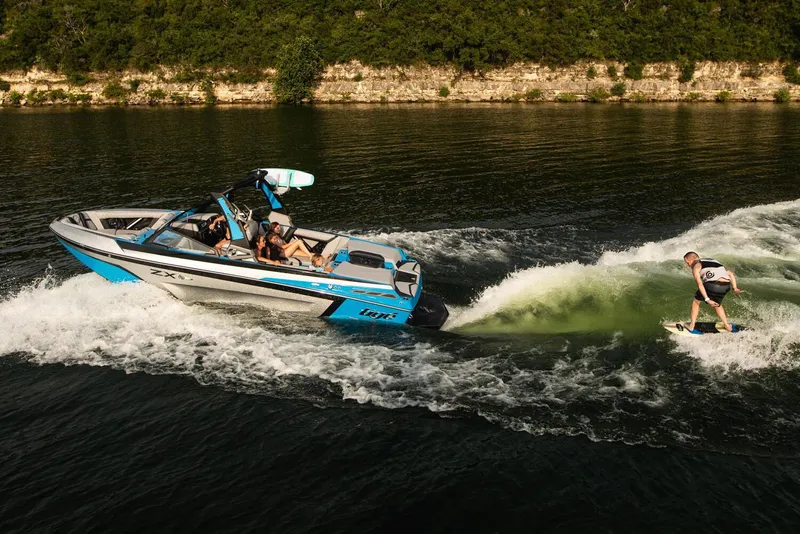 Slide: The Image of Manufacturer Provided Image: 2020 Tigé 23ZX boat towing a wakeboarder on a lake. - 15